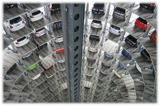 Automatyczny system parkingowy z wieloma poziomami i zaparkowanymi samochodami w różnych kolorach.